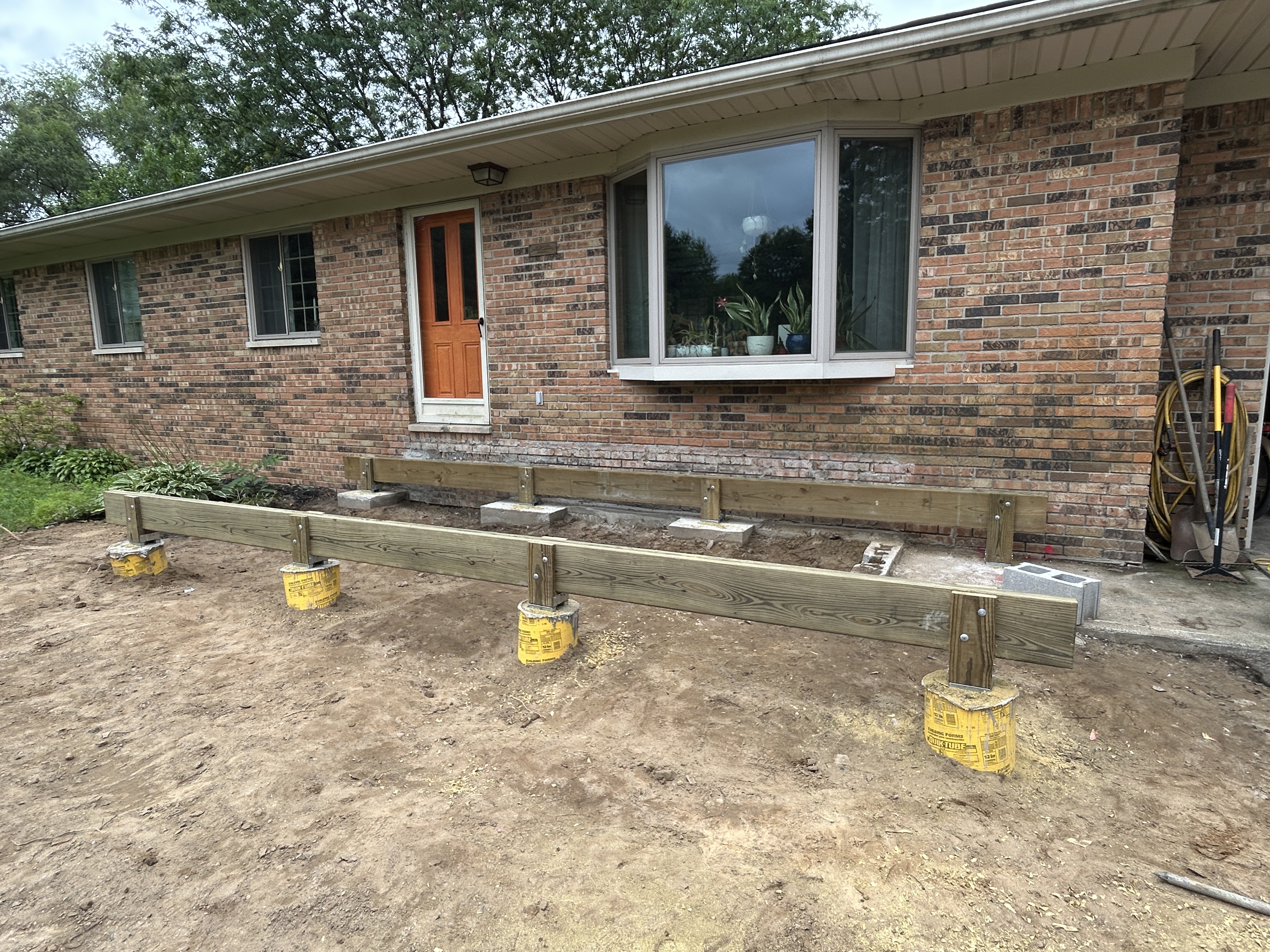 Deck footings and support beams during construction